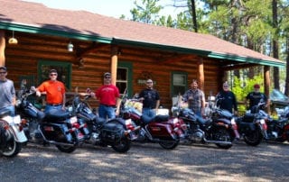 group of bikers in front of cabin