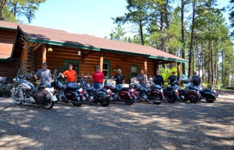 bikers in front of a cabin