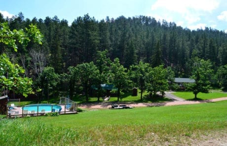 hill view of pool and cabins