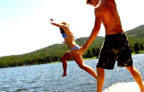 couple jumping into the lake